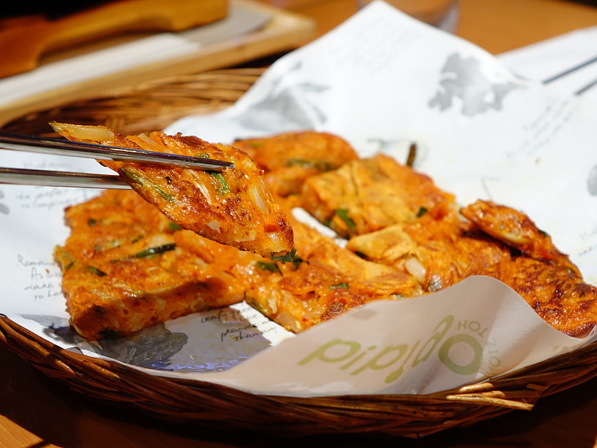 Korean Kimchi Pancake Served in Wicker Basket with Chopsticks