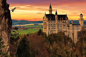 Neuschwanstein Castle at Sunset with Autumn Forest and Lake