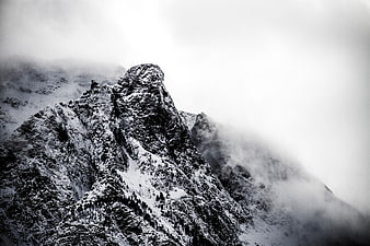 Dramatic Black and White Snowy Mountain Peak in Fog