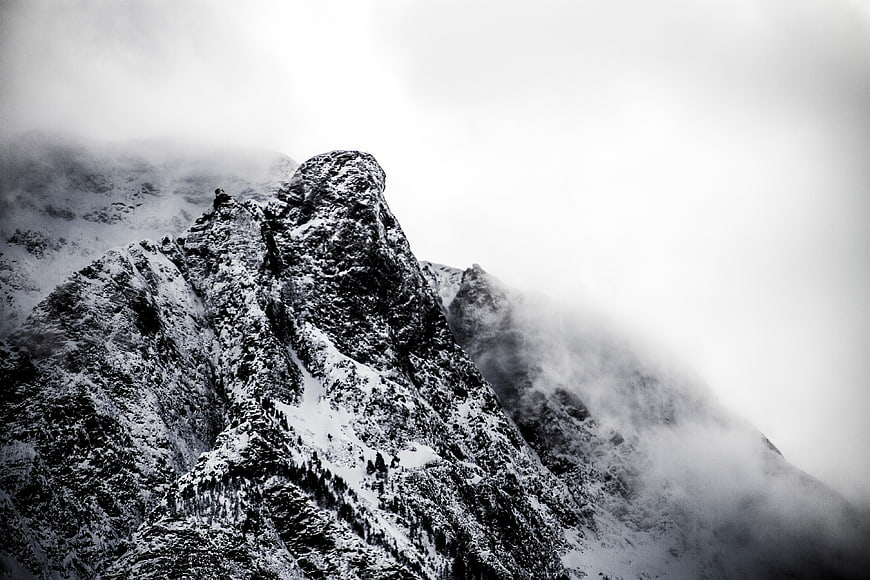 Dramatic Black and White Snowy Mountain Peak in Fog