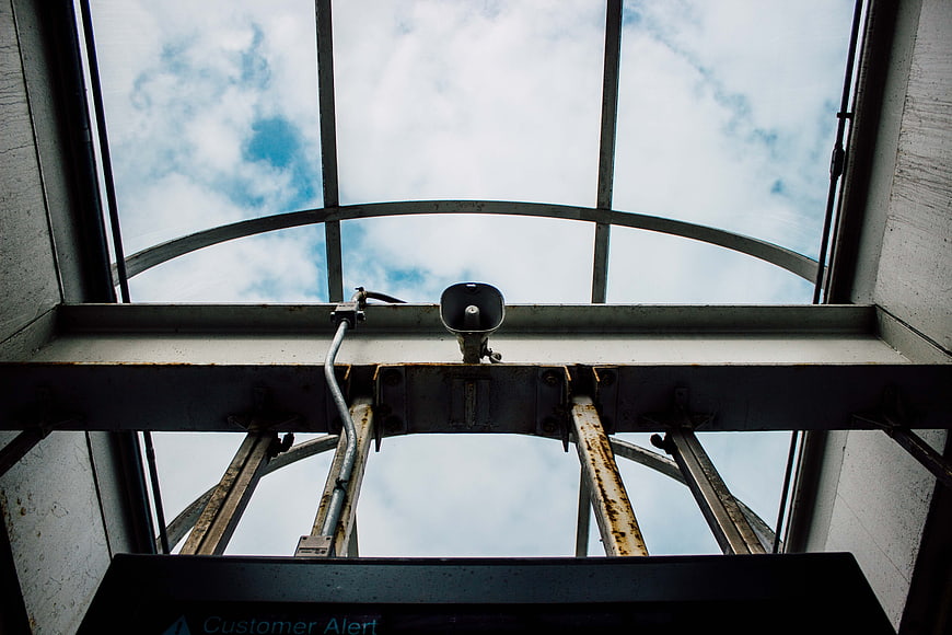 Low angle view of industrial speaker under glass roof