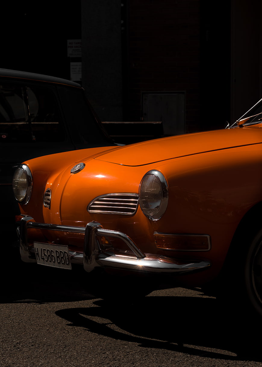 Close-up of vintage orange sports car front bumper