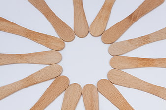 Wooden Popsicle Sticks Arranged in a Circle on White Background