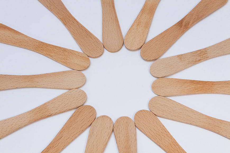 Wooden Popsicle Sticks Arranged in a Circle on White Background