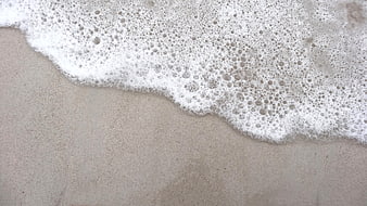 Sea Foam on Wet Sand Beach Texture