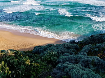 Aerial View of Turquoise Ocean Waves Crashing on Sandy Beach