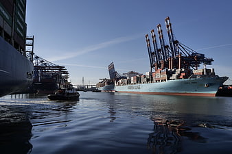 Container Ship and Cranes at Hamburg Port with Water Reflections