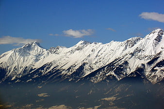 Snow-Capped Mountain Range Under Blue Sky