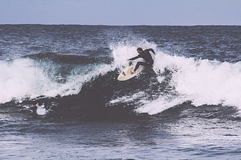 Surfer riding a wave in the ocean