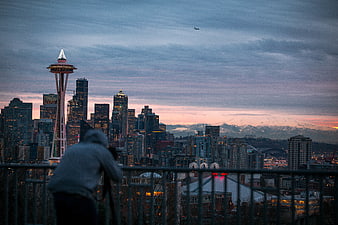Photographer capturing Seattle skyline at dusk with Space Needle