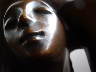 Close-up of a polished wooden sculpture face