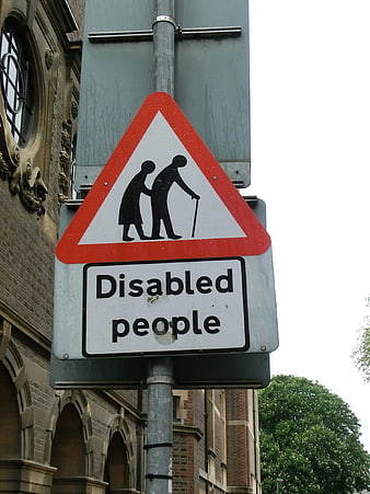 Disabled People Warning Road Sign on Street Pole