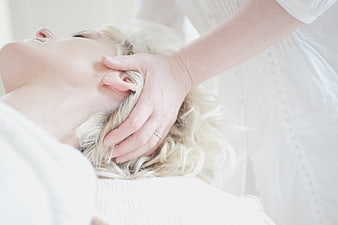 Close-up of woman receiving relaxing head massage at spa