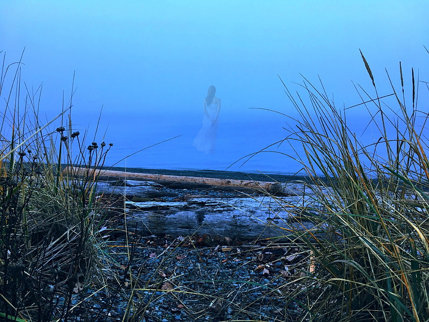 Ethereal Ghostly Figure in Foggy Coastal Landscape