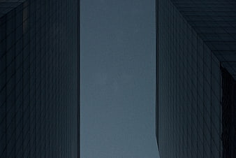 Low angle view of modern skyscrapers against blue sky