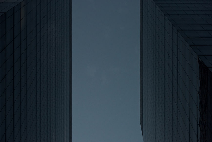 Low angle view of modern skyscrapers against blue sky