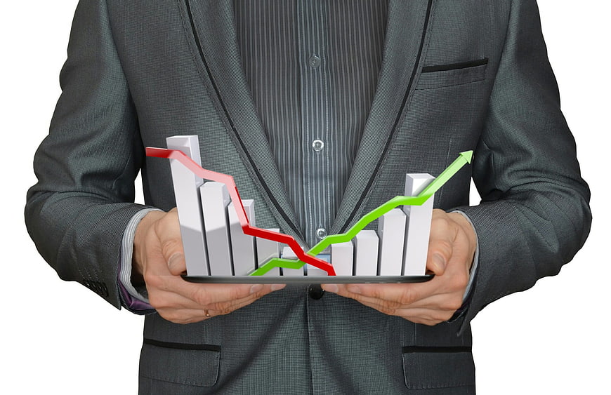Businessman holding 3D financial growth chart on tablet