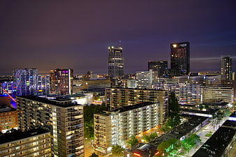 Rotterdam Cityscape at Night with Illuminated Skyscrapers