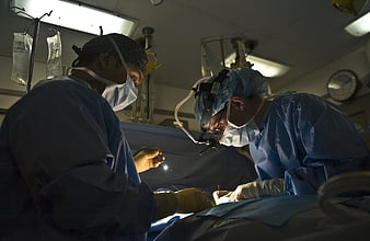 Surgeons performing surgery in operating room