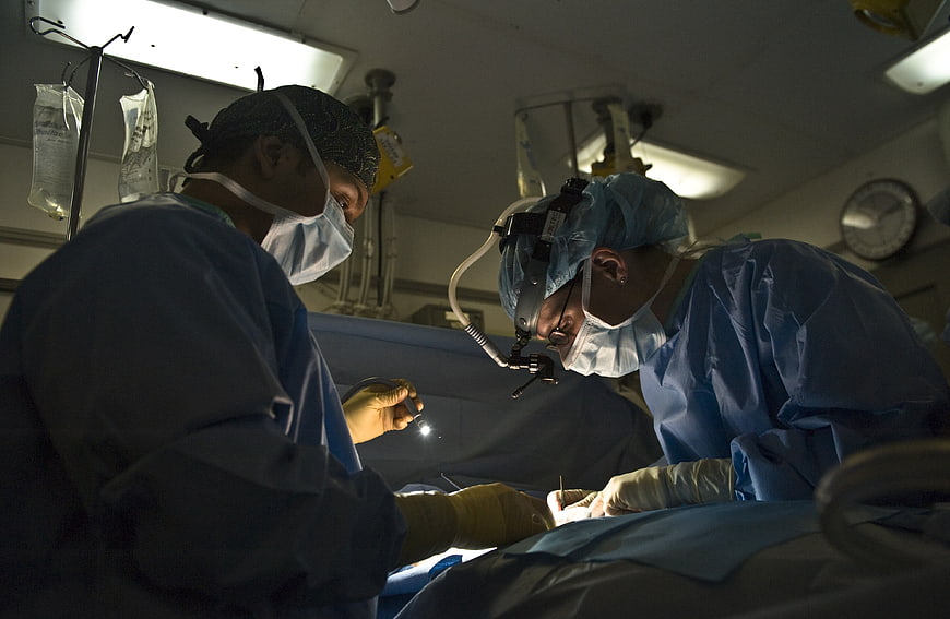 Surgeons performing surgery in operating room