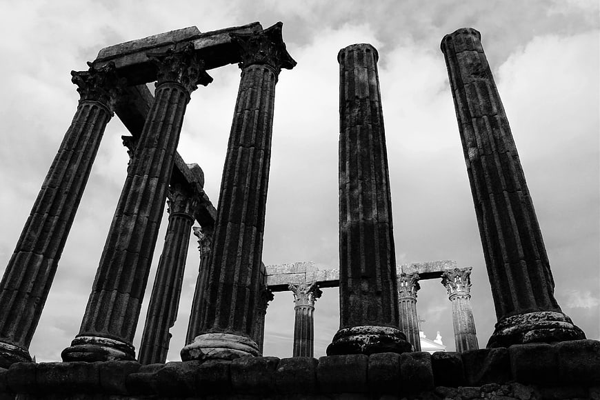 Low angle black and white view of ancient Greek temple ruins
