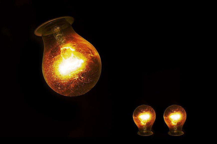 Vintage Light Bulbs Glowing on Black Background