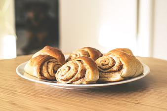 Freshly Baked Cinnamon Rolls on Wooden Table