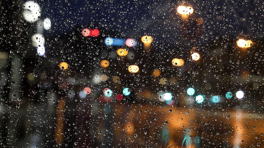 Raindrops on Window with Bokeh City Lights at Night