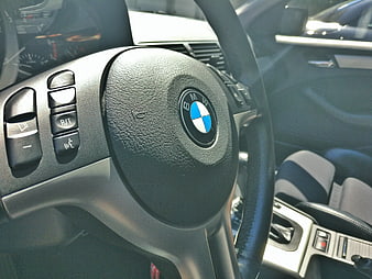 Close-up of BMW steering wheel with logo and controls