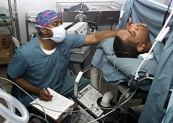 Anesthesiologist Monitoring Patient Vital Signs in Operating Room