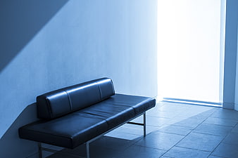 Minimalist Black Leather Sofa in Blue Tinted Room