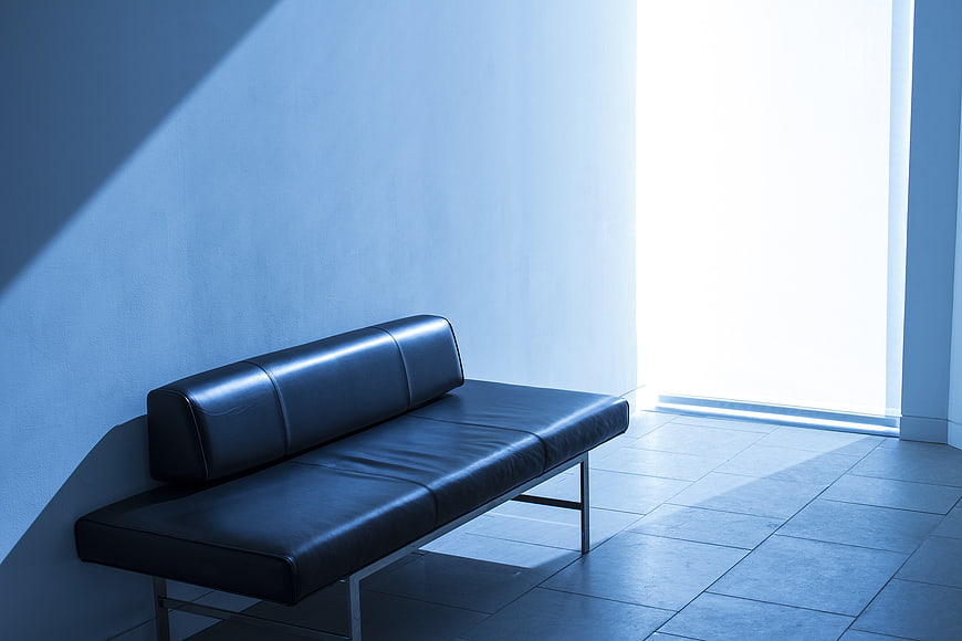Minimalist Black Leather Sofa in Blue Tinted Room