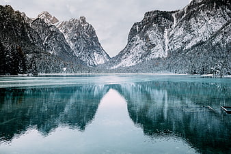 Serene Winter Lake with Snowy Mountain Reflections