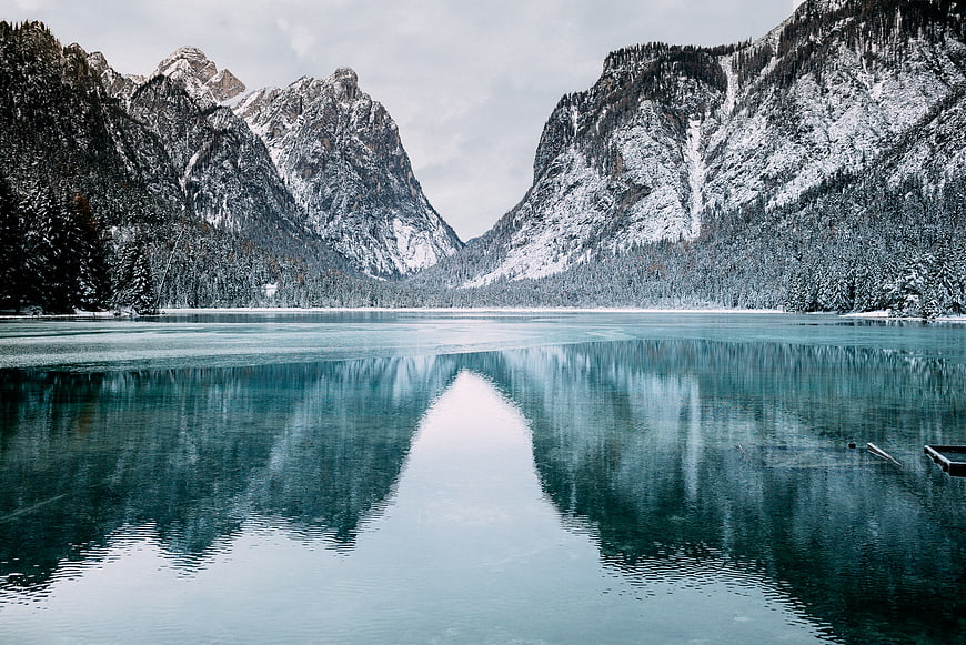 Serene Winter Lake with Snowy Mountain Reflections