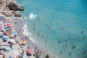 Aerial View of Crowded Beach with Turquoise Water and Colorful Umbrellas