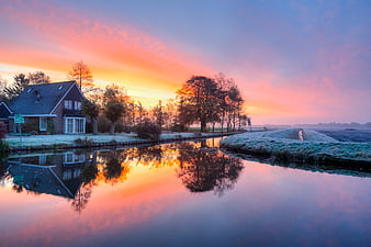 Rural Dutch House and Canal at Sunrise with Vibrant Reflections