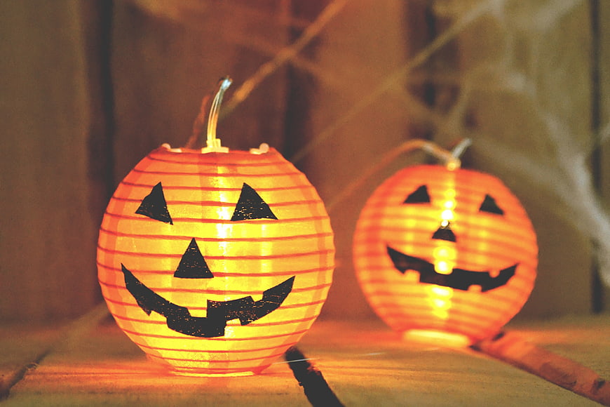 Glowing Halloween Pumpkin Lanterns on Wooden Surface