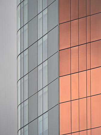 Modern Glass Building Facade with Orange Reflections