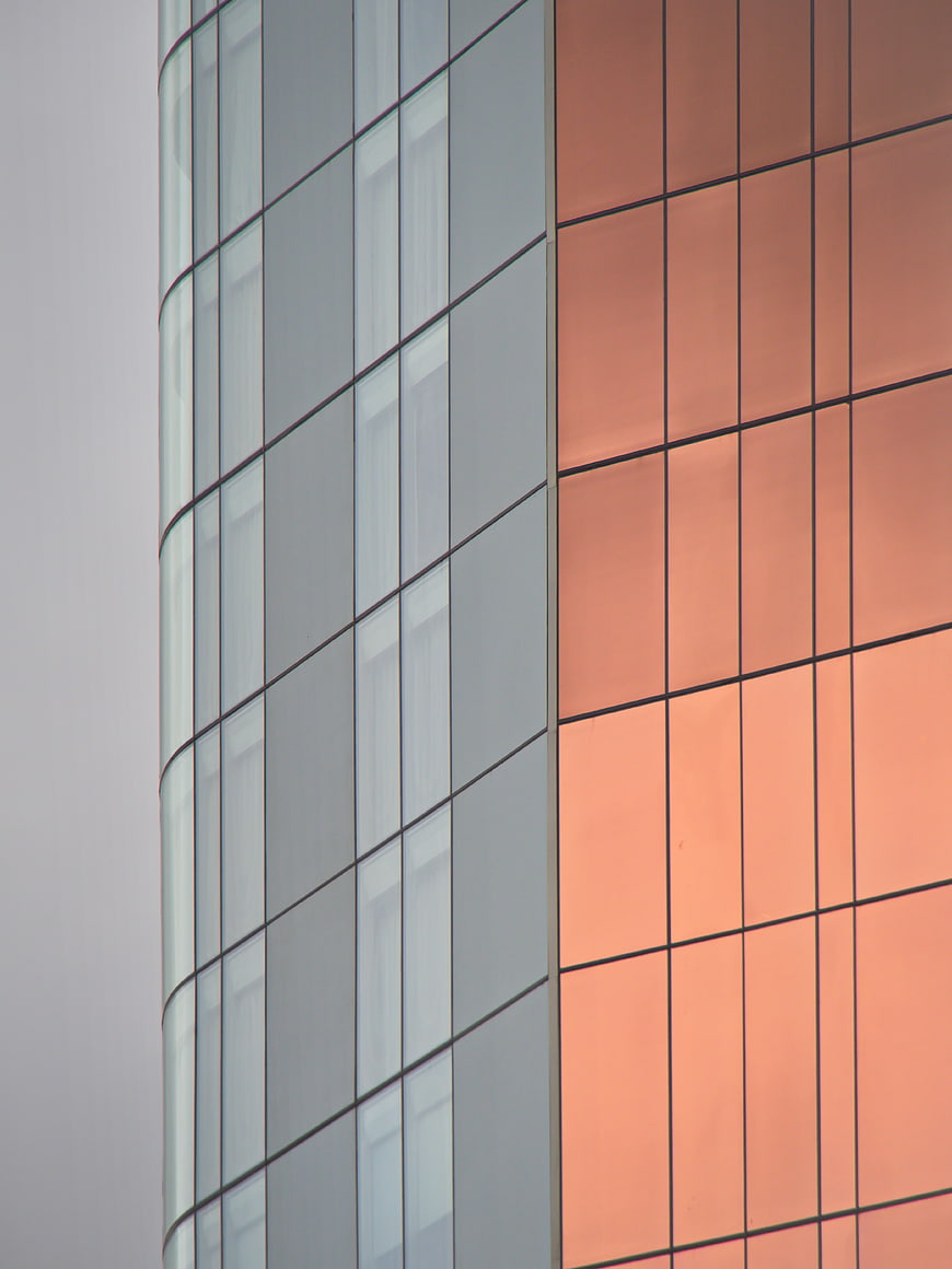 Modern Glass Building Facade with Orange Reflections