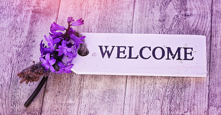 Purple Hyacinth Flower on Wooden Welcome Sign