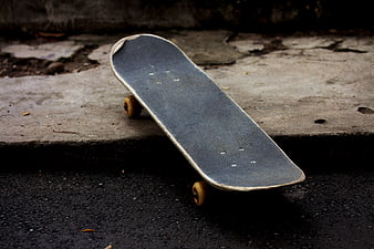 Worn Skateboard on Concrete Curb