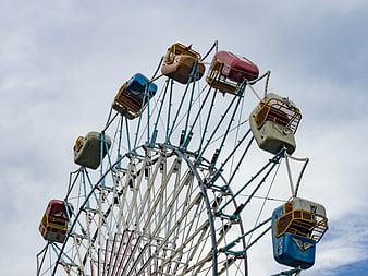 Vintage Ferris Wheel Against Cloudy Sky