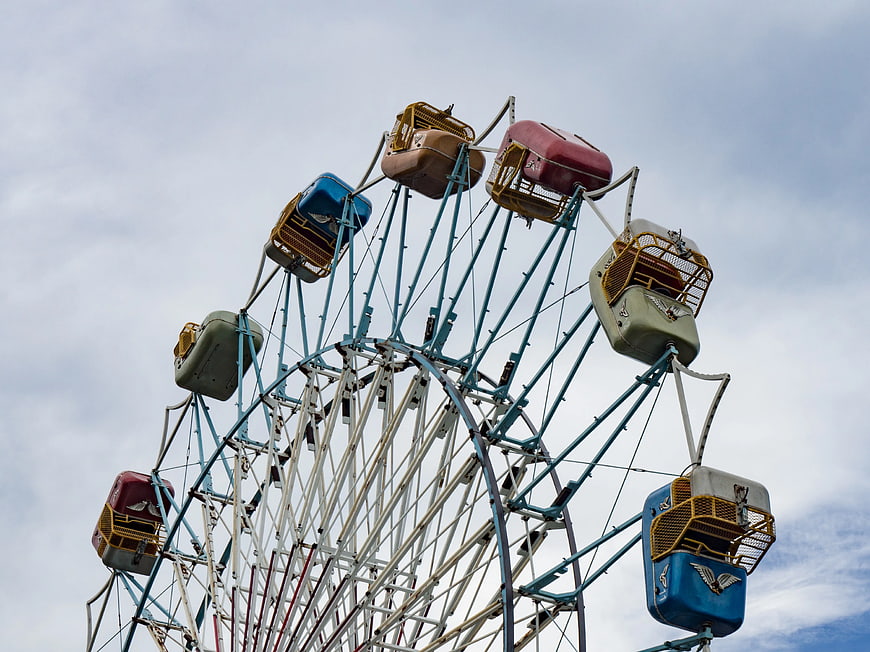 Vintage Ferris Wheel Against Cloudy Sky