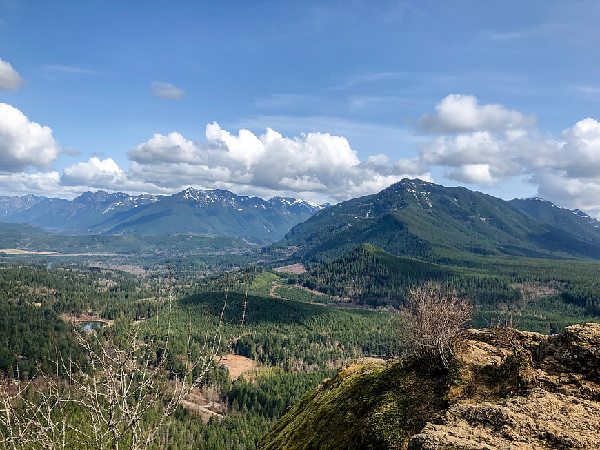 Scenic mountain landscape with green forest and blue sky