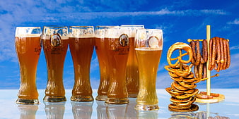 Bavarian Beer Glasses, Pretzels, and Sausages Against Blue Sky