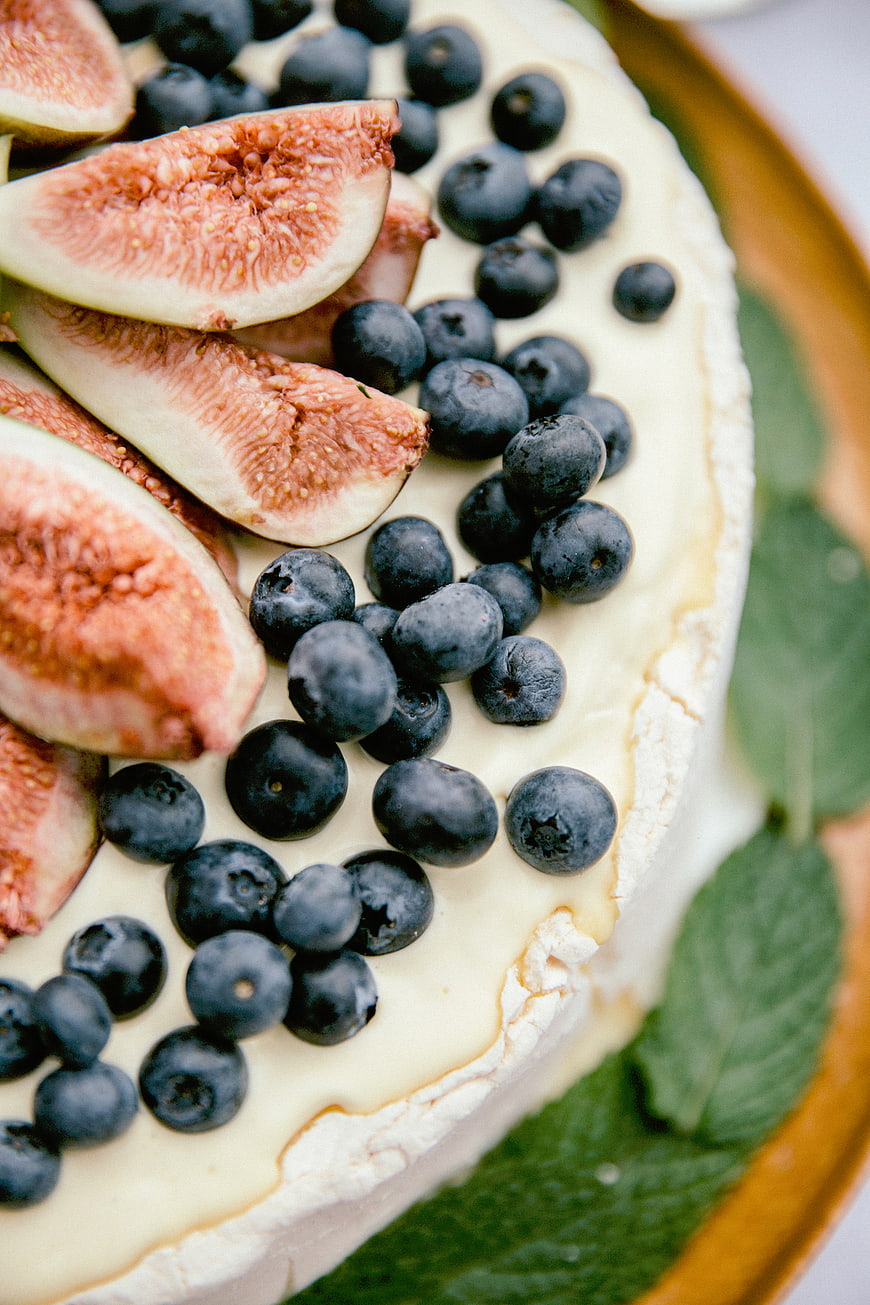 Close-up of fresh fig and blueberry dessert on a wooden plate