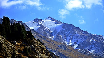 Snow-Capped Mountain Peak with Glacier and Blue Sky