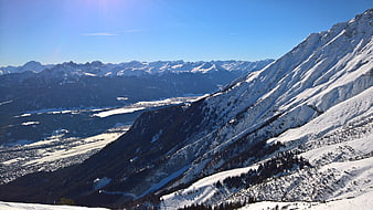 Snowy Mountain Landscape with Valley and Blue Sky