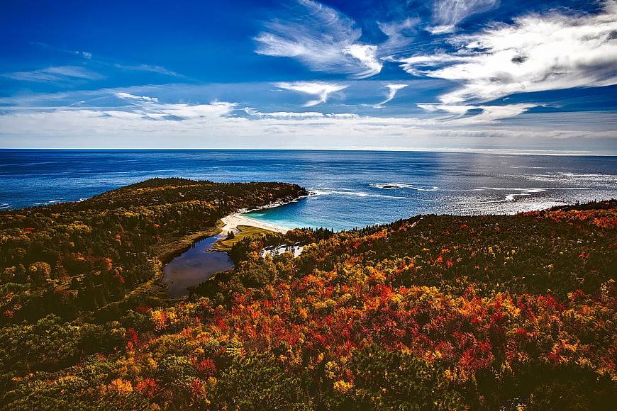 Aerial View of Autumn Forest Island and Blue Ocean Coastline