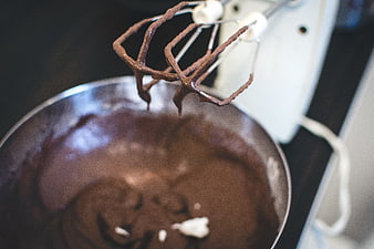Close-up of chocolate batter being mixed with electric whisk